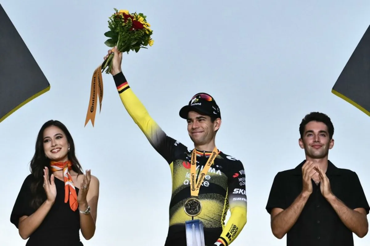 Team Visma - Lease a bike team's Belgian rider Wout van Aert celebrates on the podium after winning the 21st and final stage of the 112th edition of the Tour de France cycling race, 132.3 km between Mantes-la-Ville and Paris Champs-Élysees, on July 27, 2025. Marco BERTORELLO / AFP