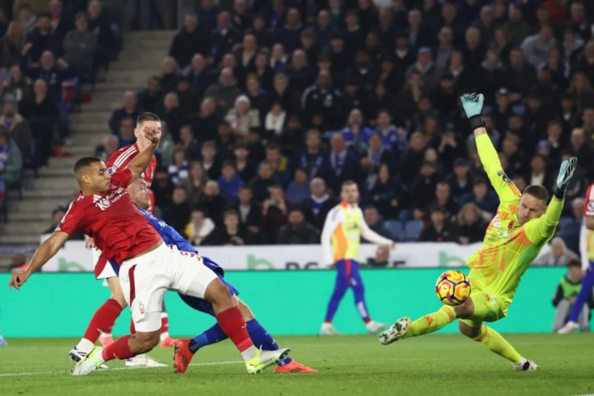 Leicester City's English striker #09 Jamie Vardy (3L) scores their first goal past Nottingham Forest's Belgian goalkeeper #26 Matz Sels during the English Premier League football match between Leicester City and Nottingham Forest at King Power Stadium in Leicester, central England on October 25, 2024.  Darren Staples / AFP