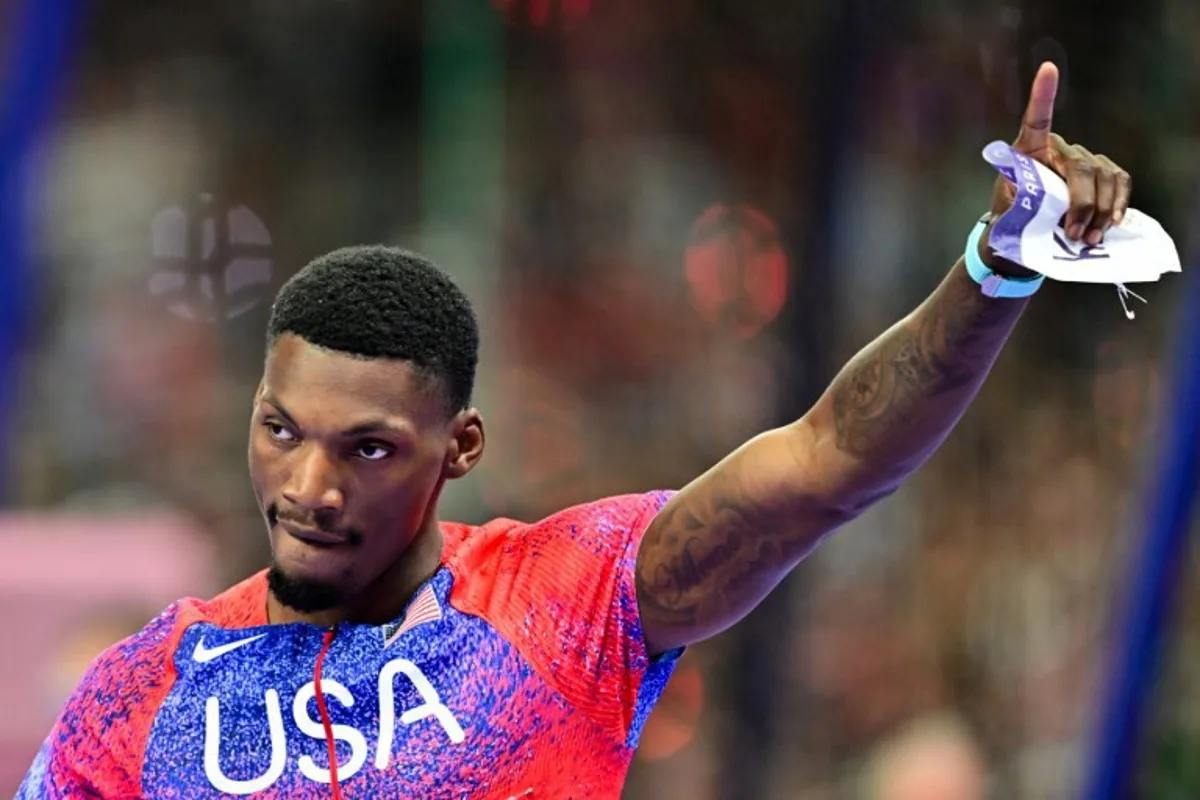 US' bronze medallists Fred Kerley celebrates after the men's 100m final of the athletics event at the Paris 2024 Olympic Games at Stade de France in Saint-Denis, north of Paris, on August 4, 2024.  Martin  BERNETTI / AFP