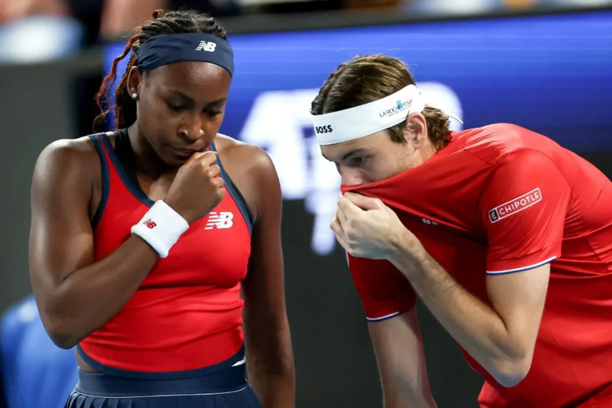 USA's Coco Gauff (L) and Taylor Fritz hits discuss tactics against Canada's Leylah Fernandez and Felix Auger-Aliassime during their doubles match at the United Cup tennis tournament in Perth on December 29, 2024.  COLIN MURTY / AFP