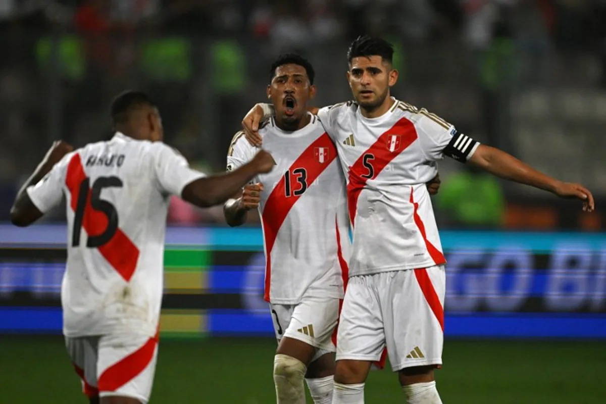 Peru's defender #15 Miguel Araujo, midfielder #13 Jesus Castillo and defender #05 Carlos Zambrano celebrate their victory at the end of the 2026 FIFA World Cup South American qualifiers football match between Peru and Uruguay at the National stadium in Lima, on October 10, 2024.  ERNESTO BENAVIDES / AFP