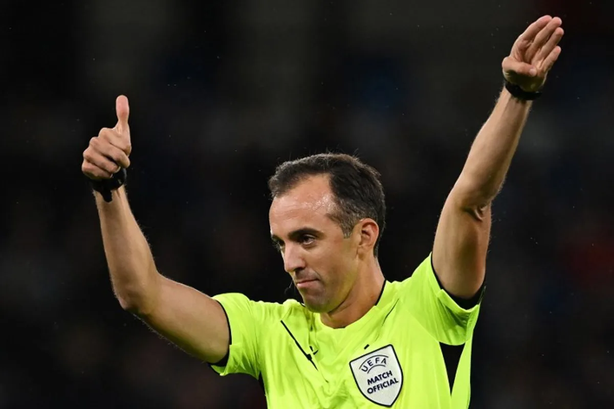 Portuguese referee Joao Pinheiro gestures during the UEFA Champions League Group G football match between Manchester City and FC Crvena Zvezda (Red Star Belgrade) at the Etihad Stadium in Manchester, north west England, on September 19, 2023.  Paul ELLIS / AFP