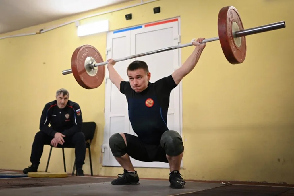 Russian weightlifter Oleg Musokhranov, 28, warms up before competing in his under 61kg category at the Russia Cup in Tula on January 28, 2024. Natalia KOLESNIKOVA / AFP