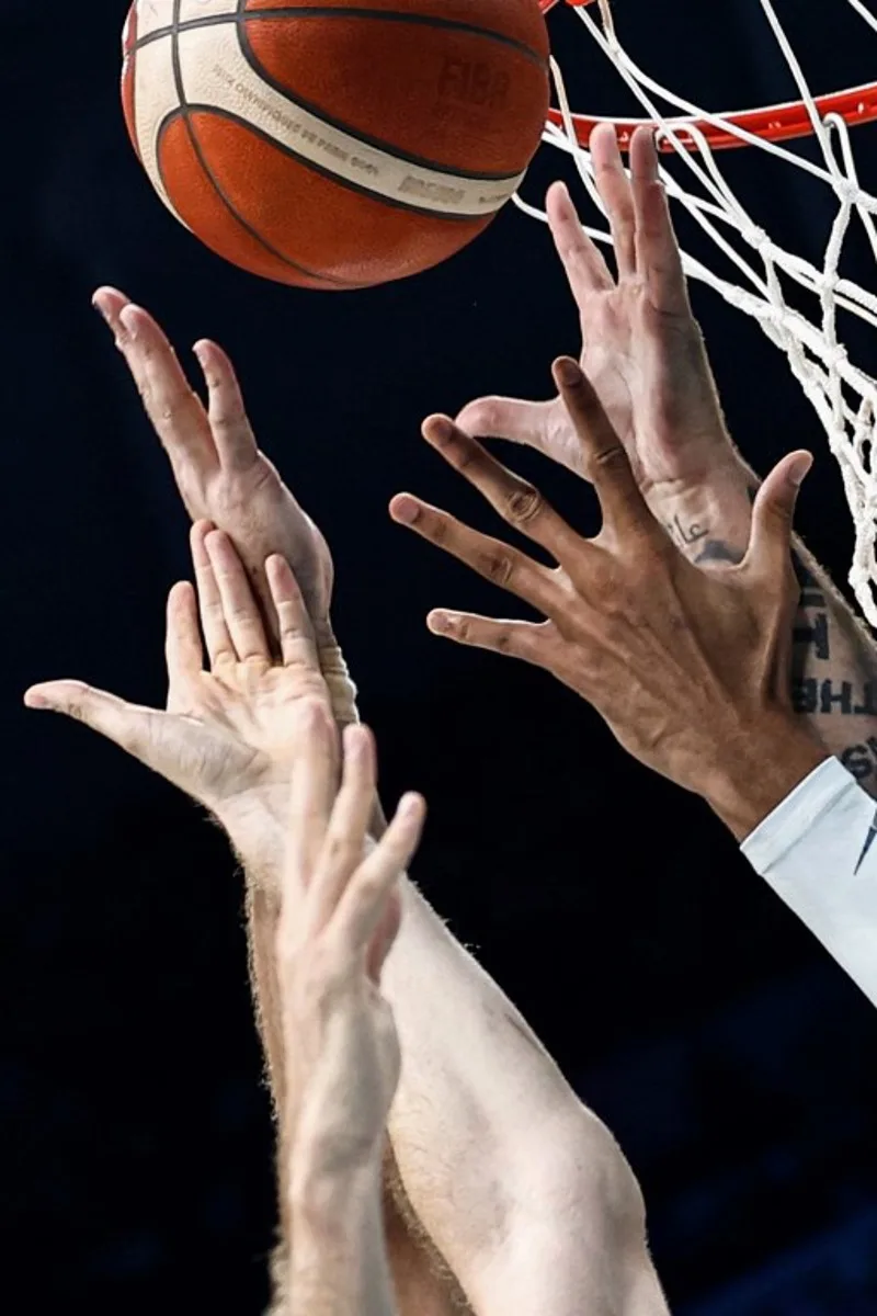 Players go for a rebound in the men's preliminary round group A basketball match between Spain and Greece during the Paris 2024 Olympic Games at the Pierre-Mauroy stadium in Villeneuve-d'Ascq, northern France, on July 30, 2024.  Sameer Al-Doumy / AFP