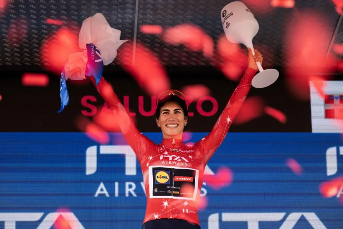Lidl Trek Italian rider Elisa Balsamo wearing the best sprinter's red jersey (Maglia Rossa) celebrates on the podium of the Giro d'Italia Women 2026 - Tour of Italy Women cycling race in Saluzzo, Northwestern Italy, on June 7, 2026. MARCO BERTORELLO / AFP