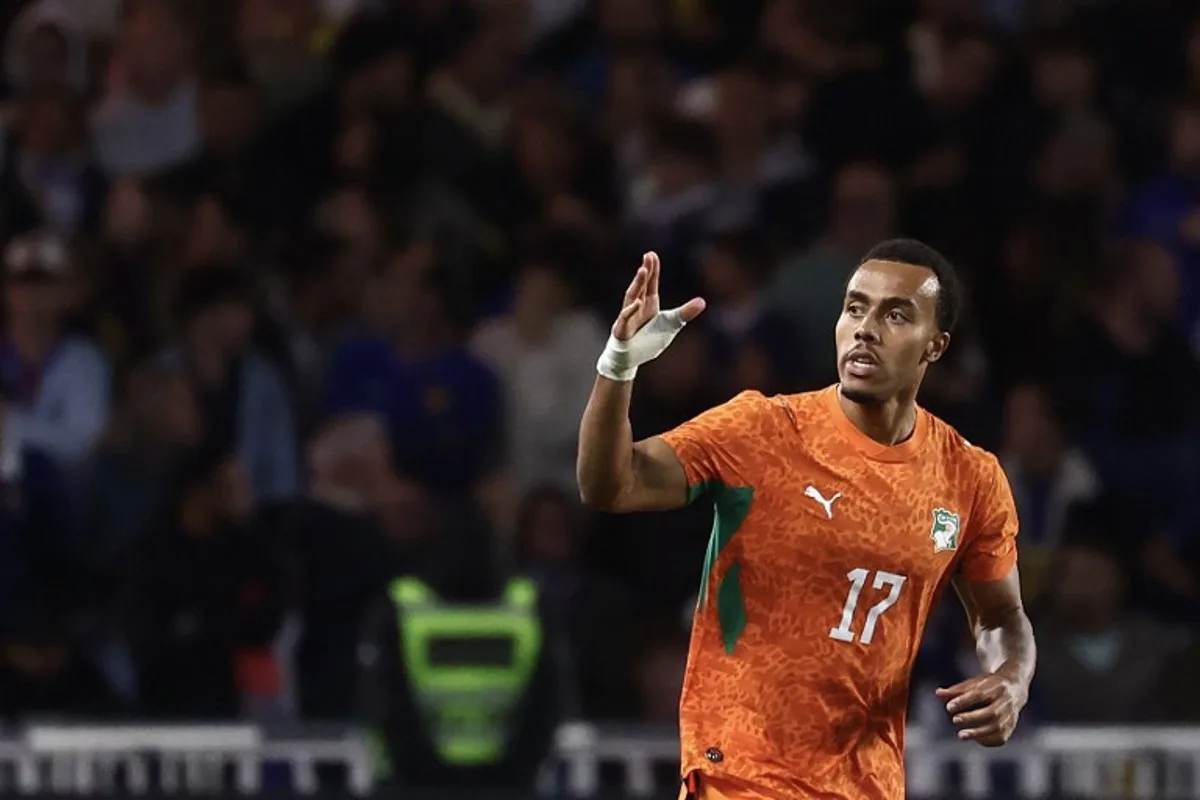 Ivory Coast's defender #17 Guela Doue celebrates scoring the equalizing goal during the international friendly football match between France and Ivory Coast ahead of the 2026 FIFA World Cup football tournament at the Stade de la Beaujoire in Nantes, western France, on June 4, 2026. FRANCK FIFE / AFP