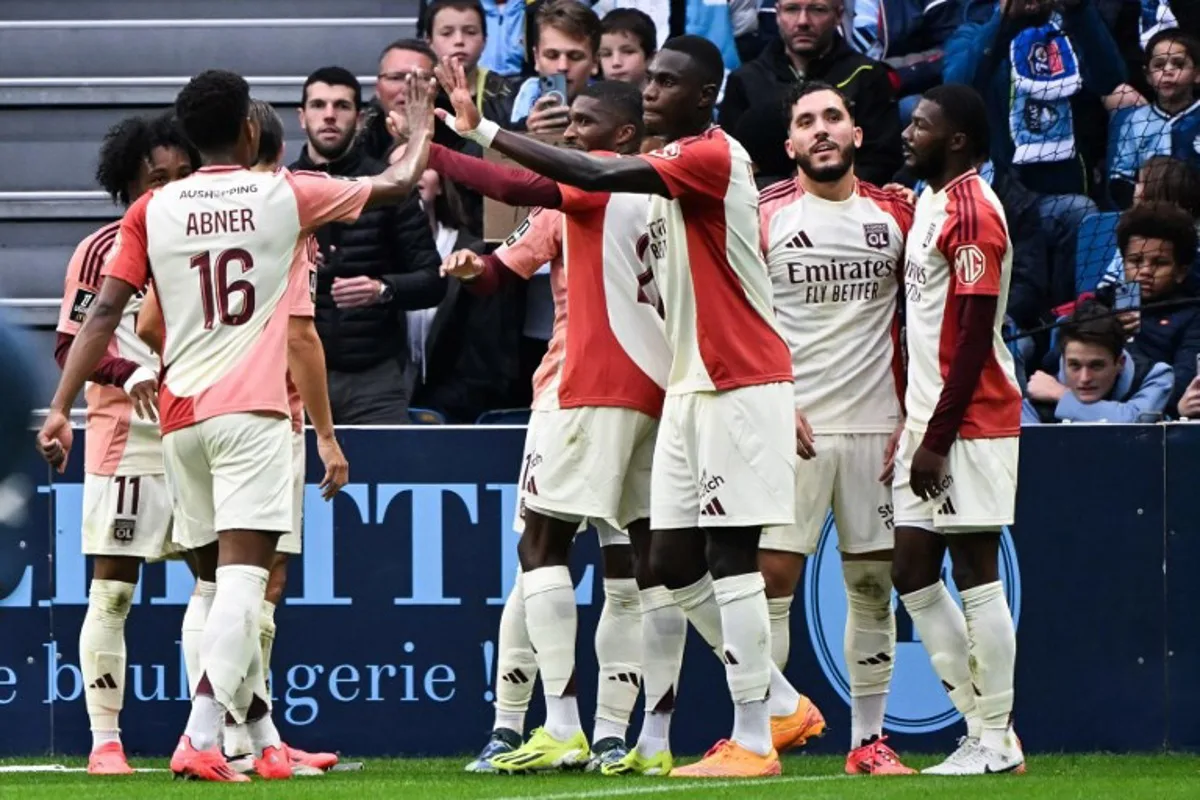 Lyon's French forward #10 Alexandre Lacazette (unseen) celebrates with teammates after scoring his team's third goal during the French L1 football match between Le Havre AC and Olympique Lyonnais (OL) at Oceane stadium in Le Havre, western France, on October 20, 2024.   Lou BENOIST / AFP