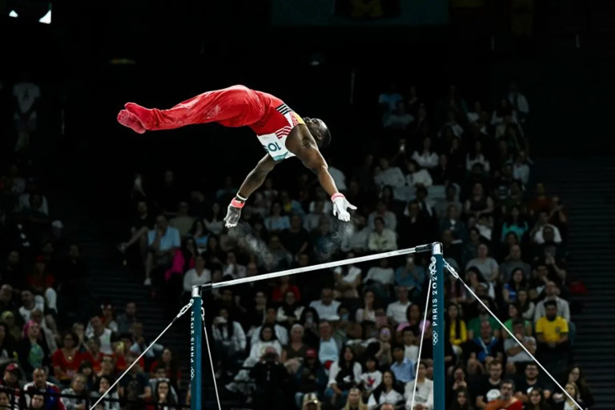 Belgium's Noah Kuavita competes in the horizontal bar event of the artistic gymnastics men's qualification during the Paris 2024 Olympic Games at the Bercy Arena in Paris, on July 27, 2024.  Gabriel BOUYS / AFP