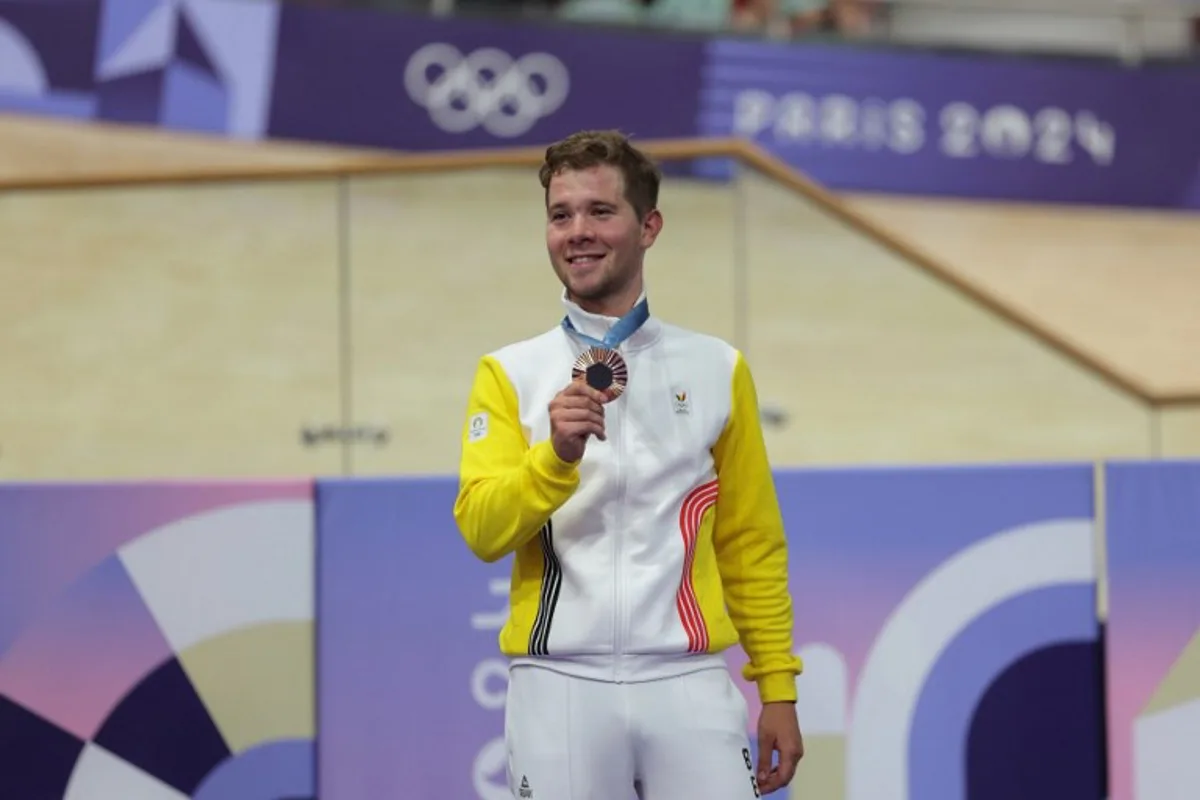 Belgium's Fabio Van Den Bossche  poses on the podium of the men's track cycling omnium event of the Paris 2024 Olympic Games at the Saint-Quentin-en-Yvelines National Velodrome in Montigny-le-Bretonneux, south-west of Paris, on August 8, 2024.  Thomas SAMSON / AFP