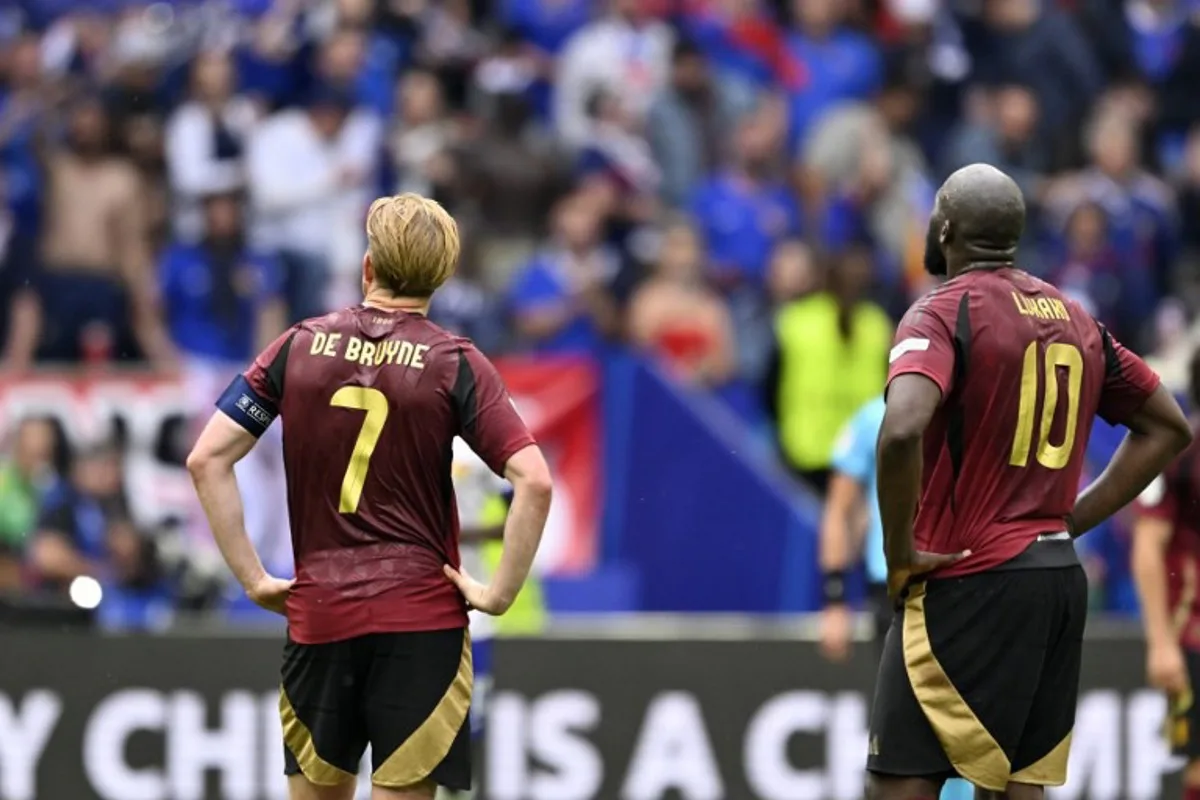 Belgium's midfielder #07 Kevin De Bruyne and Belgium's forward #10 Romelu Lukaku react after France's forward #12 Randal Kolo Muani (unseen) scored a goal during the UEFA Euro 2024 round of 16 football match between France and Belgium at the Duesseldorf Arena in Duesseldorf on July 1, 2024.  INA FASSBENDER / AFP