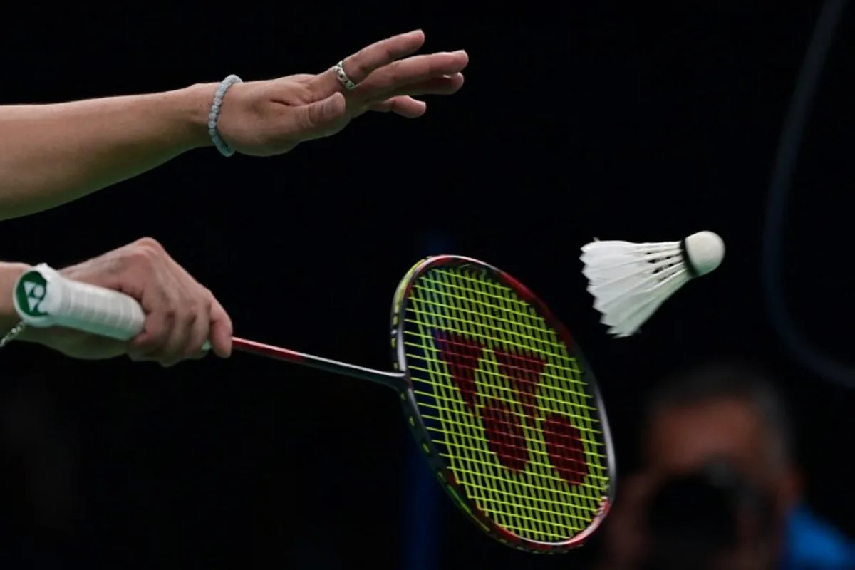 Canada's Xingyu Dong serves against Brazil's Davi Carvalho and Fabricio Rocha in the Badminton men's doubles final event of the Pan American Games Santiago 2023, at the Centro de Entrenamiento Olimpico in Santiago on October 25, 2023.  Pablo VERA / AFP