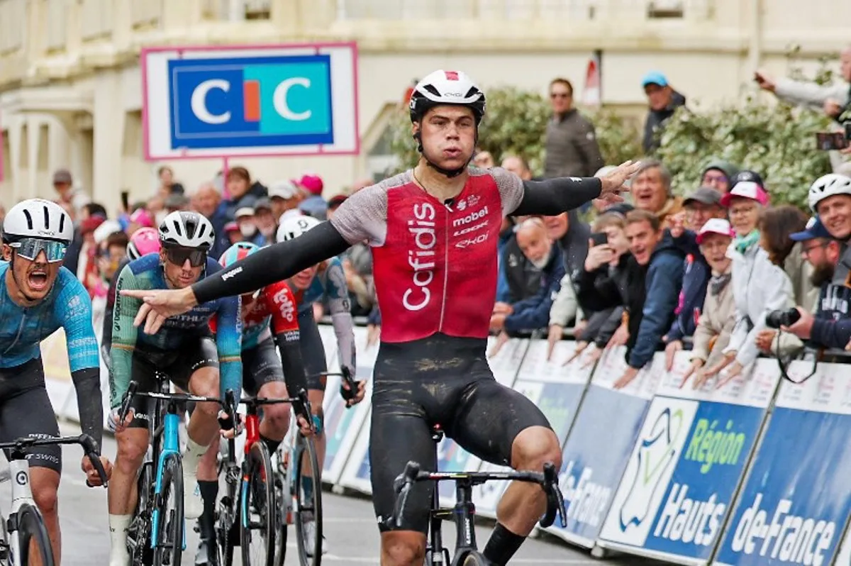 Team Cofidis' Belgium rider Milan Fretin (C) celebrates as he crosses the line to win the first stage of the "4 jours de Dunkerque" (Four days of Dunkirk) cycling race, 168km from Dunkirk to Le Touquet, in northern France, on May 14, 2024.  FRANCOIS LO PRESTI / AFP