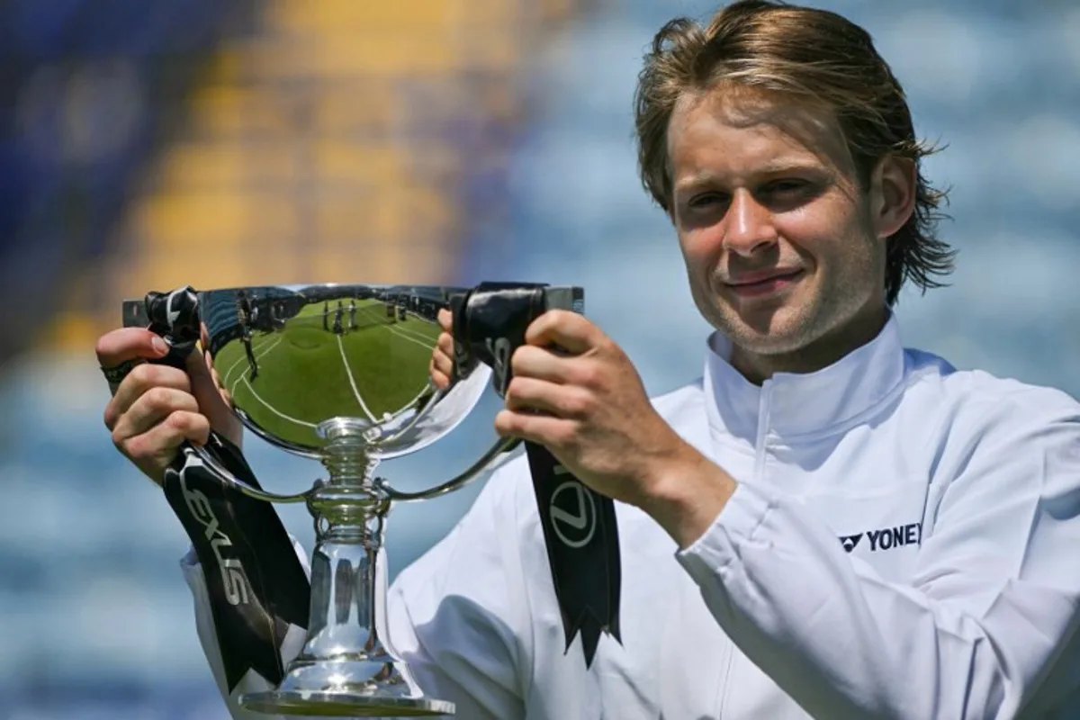 Belgium's Zizou Bergs poses with the winner's trophy after beating France's Ugo Humbert in their men's final tennis match on day seven of the Lexus Eastbourne Open at Devonshire Park, Eastbourne, on the south coast of England on June 28, 2026.  Glyn KIRK / AFP
