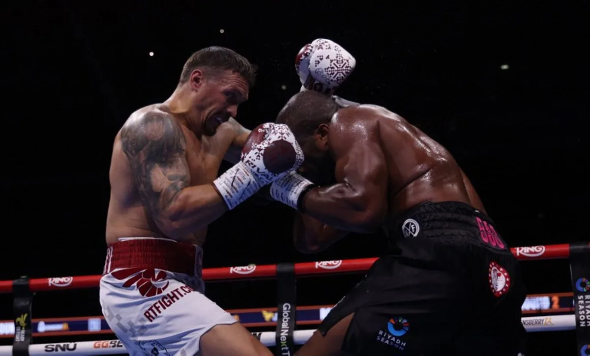 Ukraine's Oleksandr Usyk (L) and Britain's Daniel Dubois fight during their undisputed world heavyweight boxing title bout at Wembley Stadium in London on July 19, 2025. Adrian Dennis / AFP