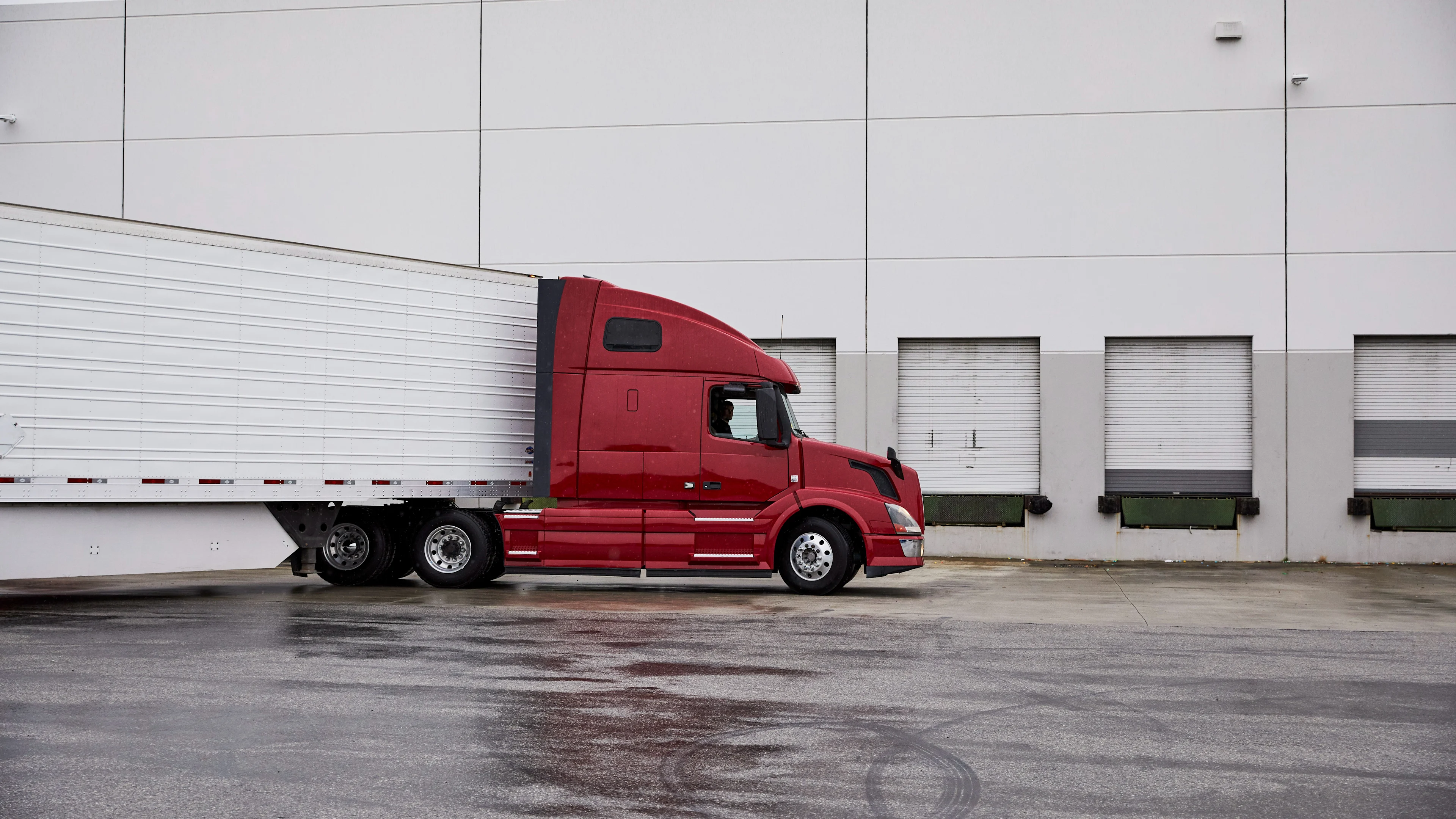 Red tractor trailer at shipping bay