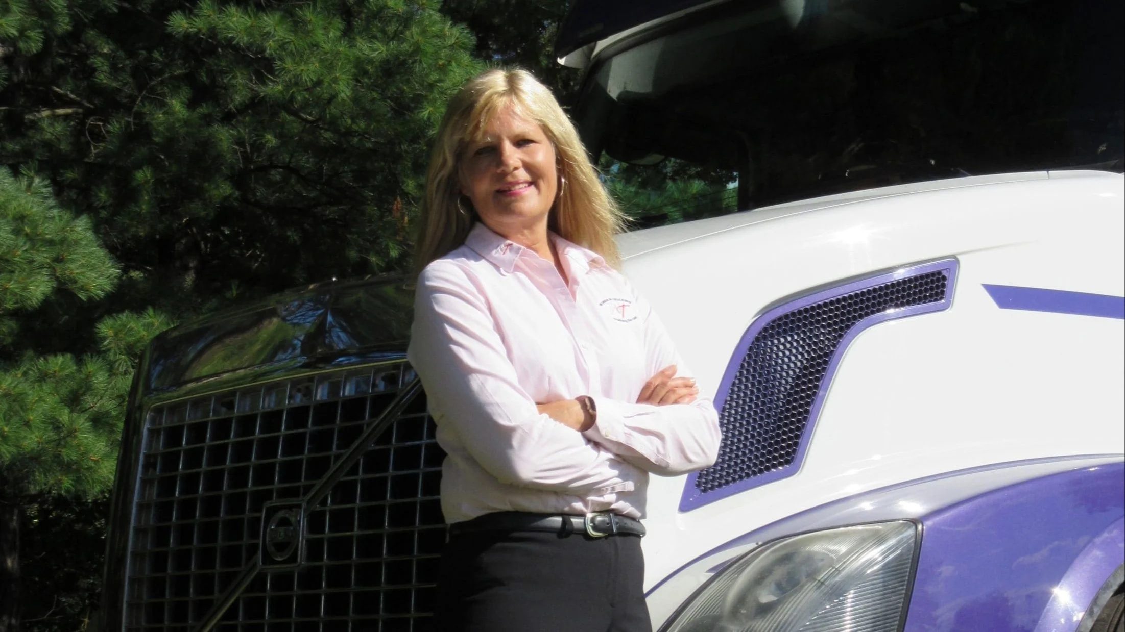 Woman in front of truck.