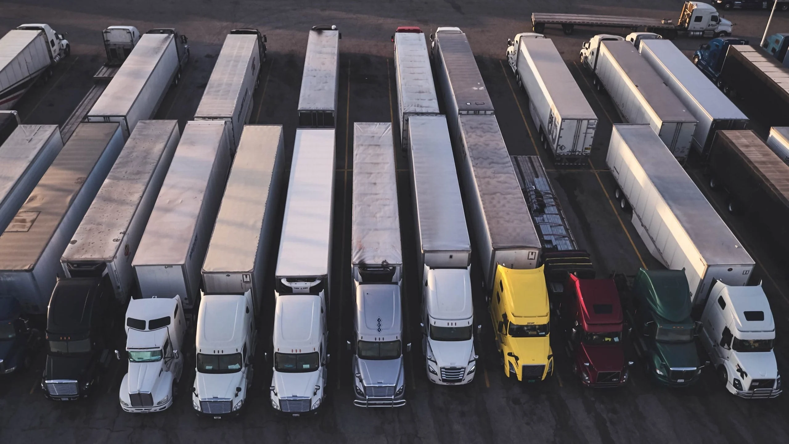 Overhead view of trucks parked in rows.
