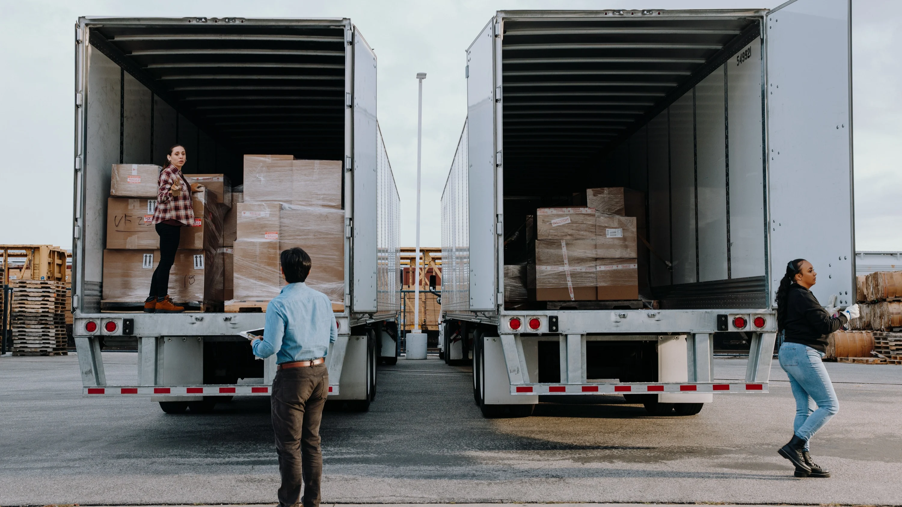 Two trucks with backs open