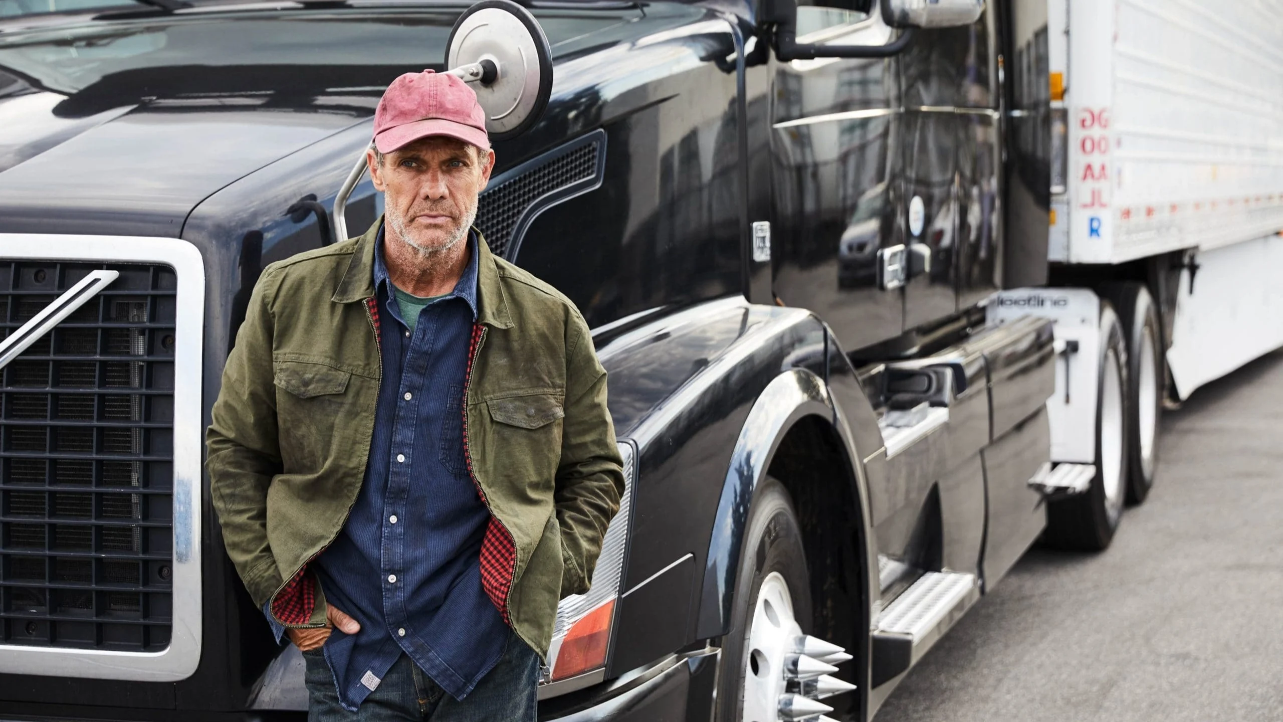 Man leaning against truck.