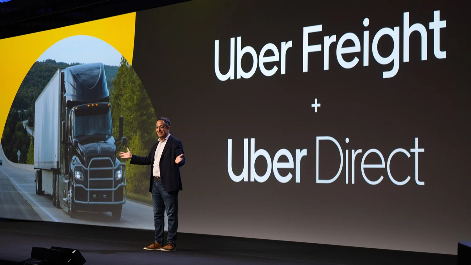 Man standing on conference stage.