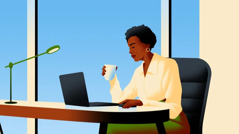 Woman drinking coffee at desk.