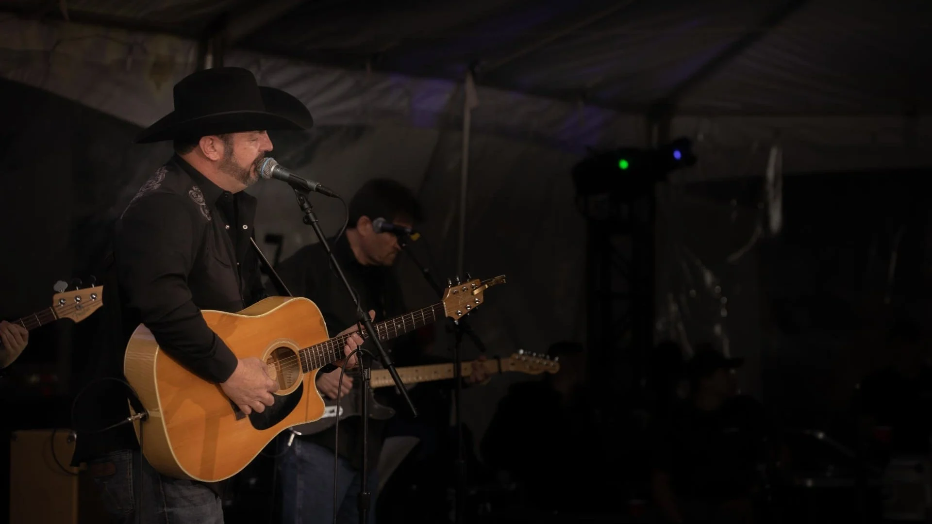 Tony Justice singing and playing the guitar.
