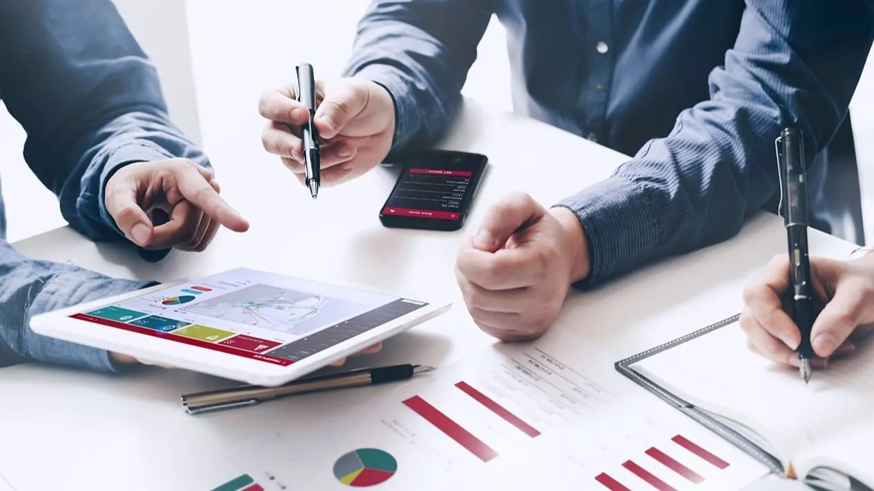 Men working at a desk.