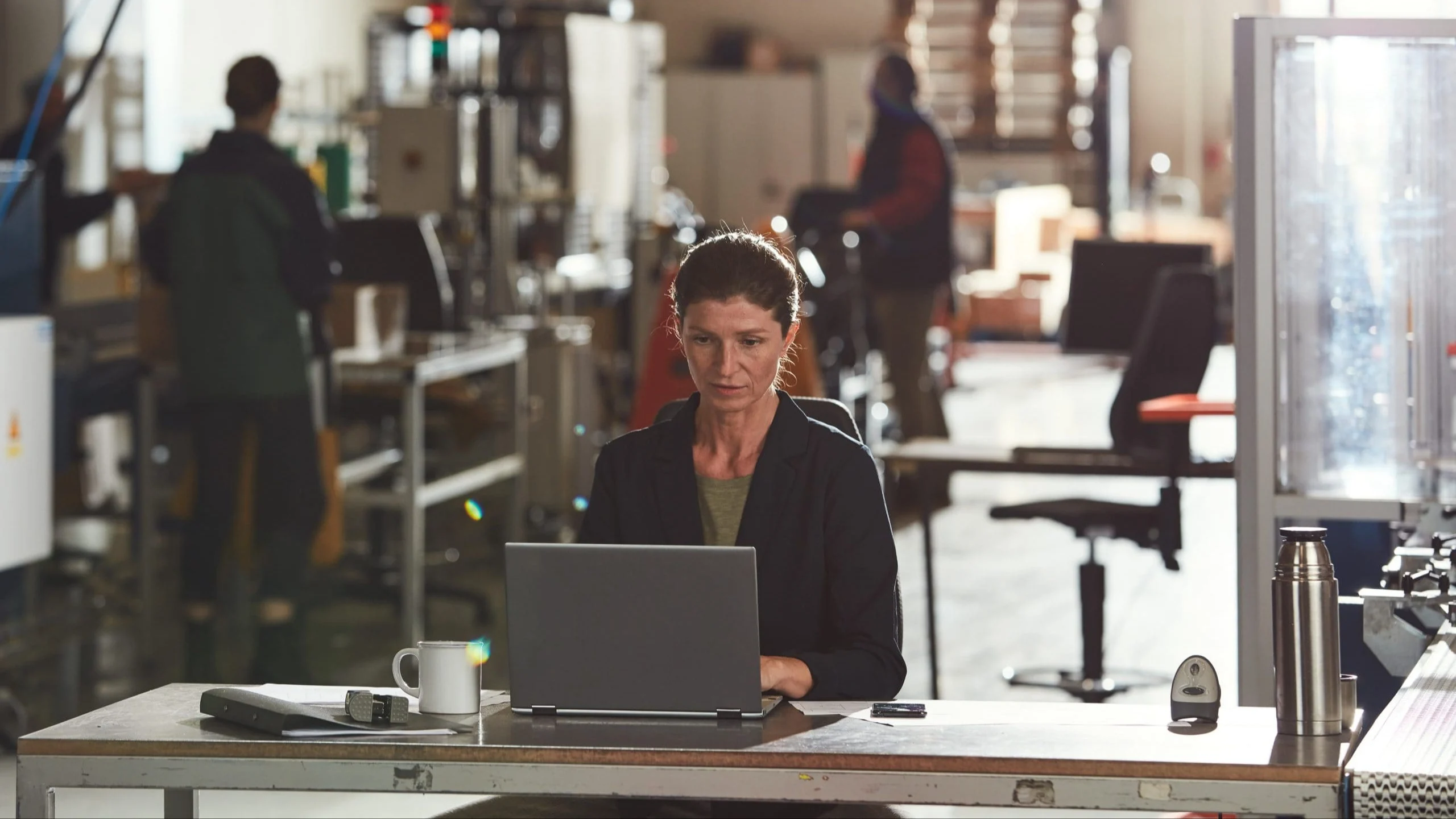 Woman sitting at desk in warehouse.