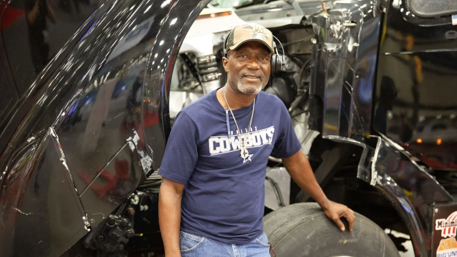 Man smiling with truck.