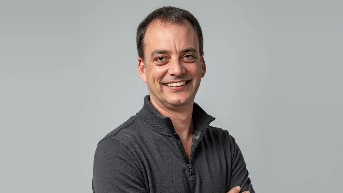 Headshot of Amir Pelleg, Chief Product Officer at Uber Freight, smiling against a neutral grey background.