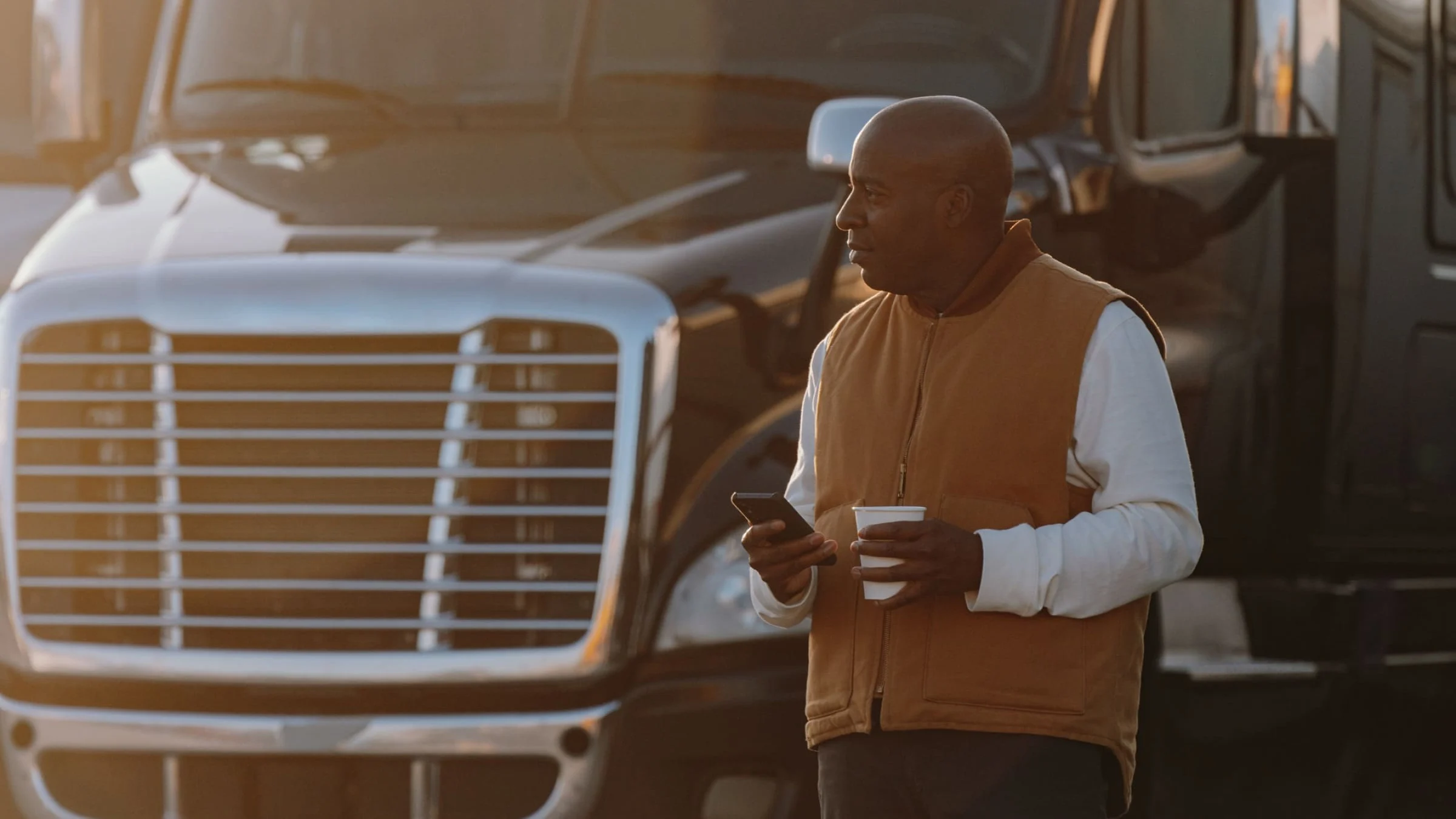 Man on mobile phone in front of truck