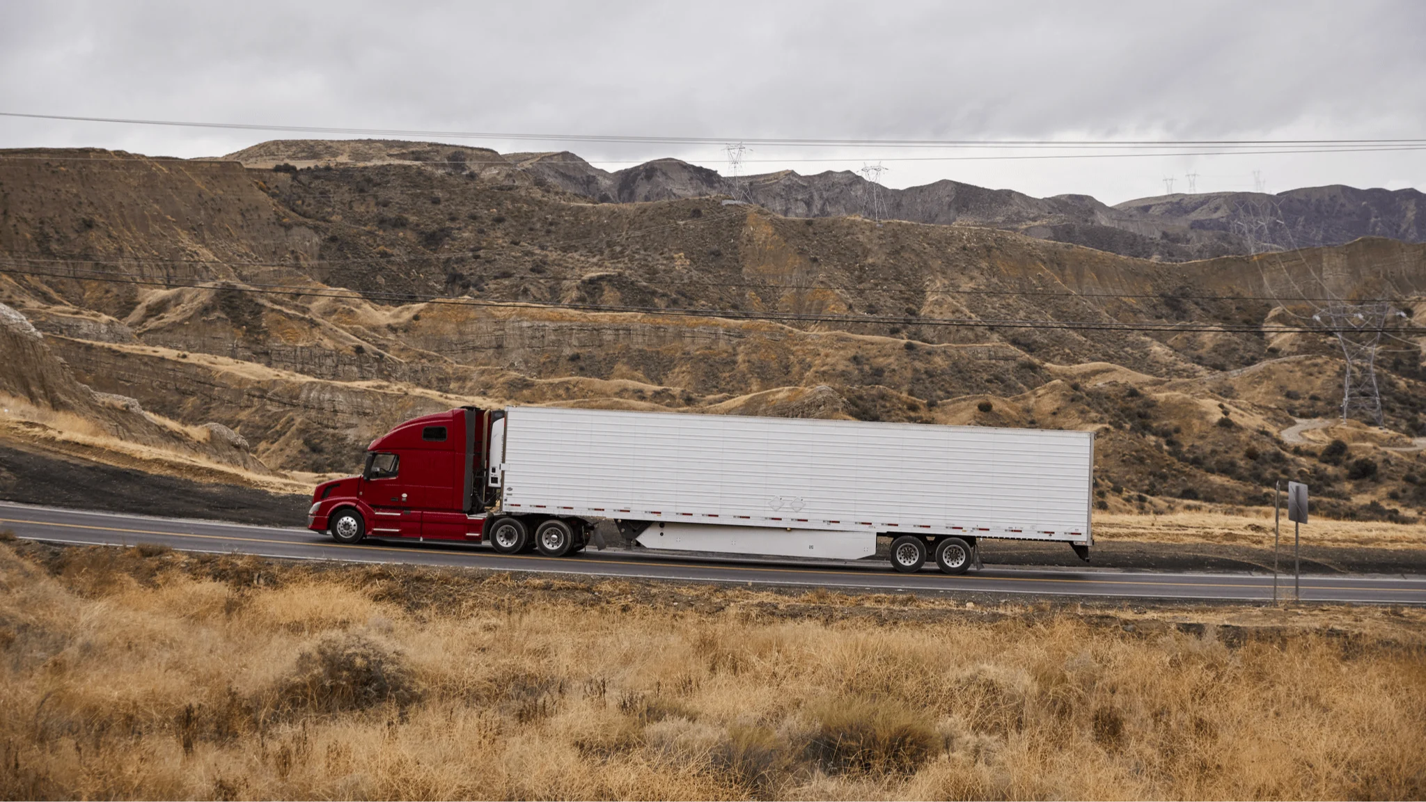 Red truck driving on road.