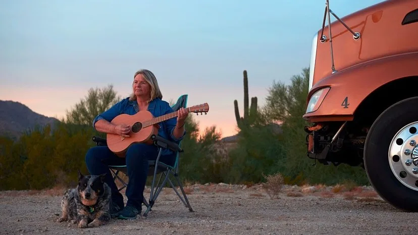 Woman playing the guitar.
