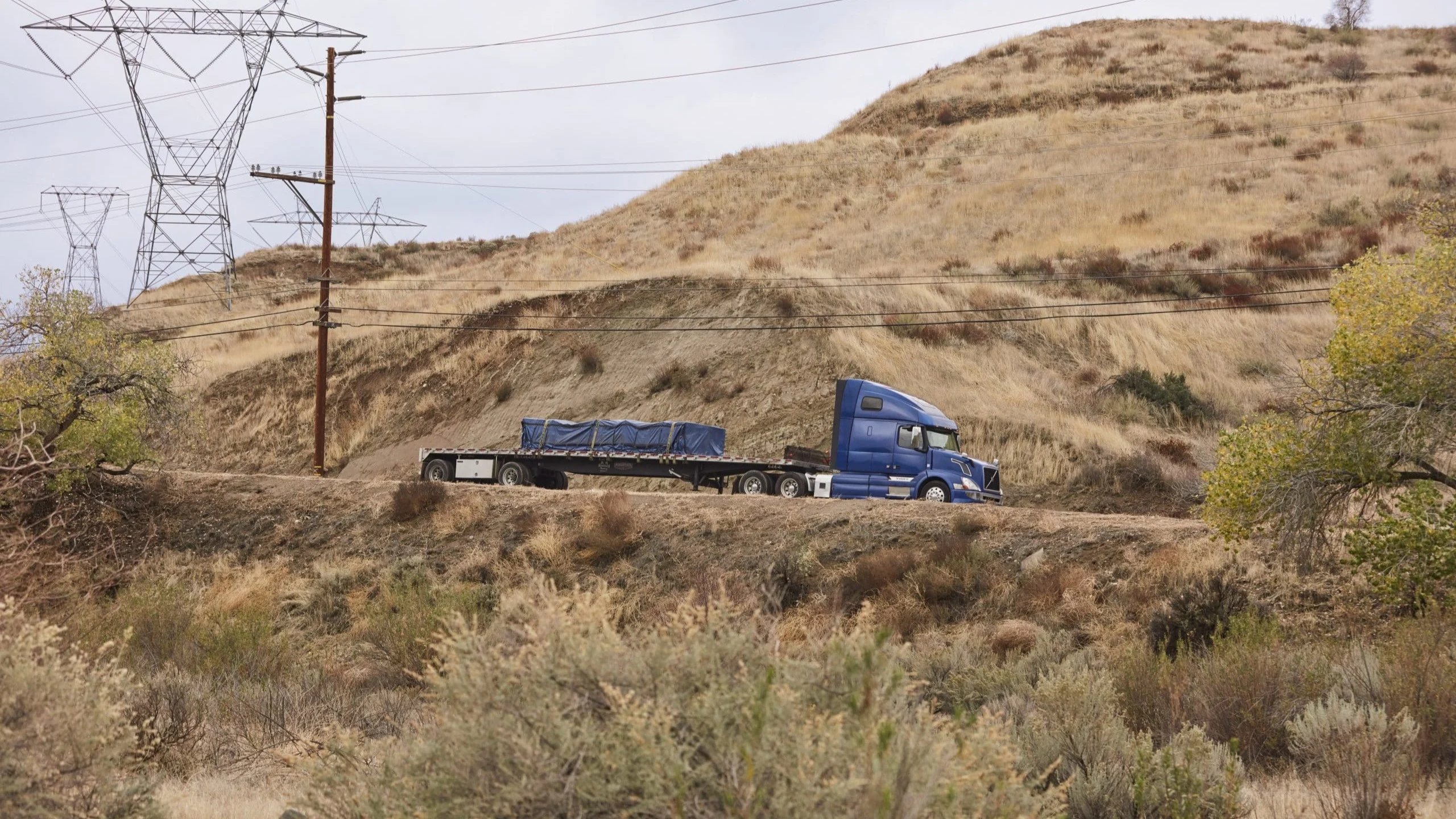 Blue truck driving on road.