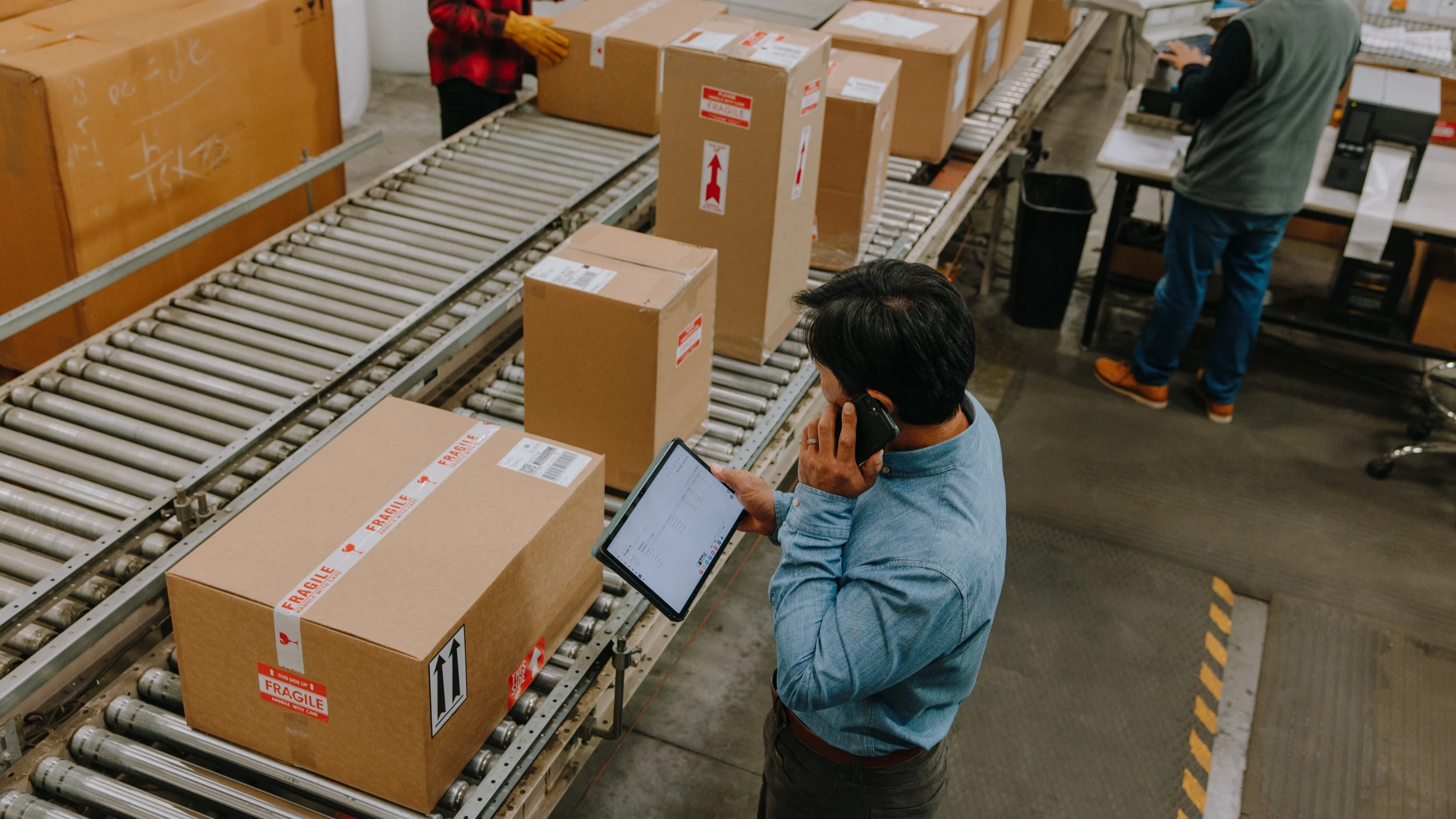 Worker inspecting a conveyor belt