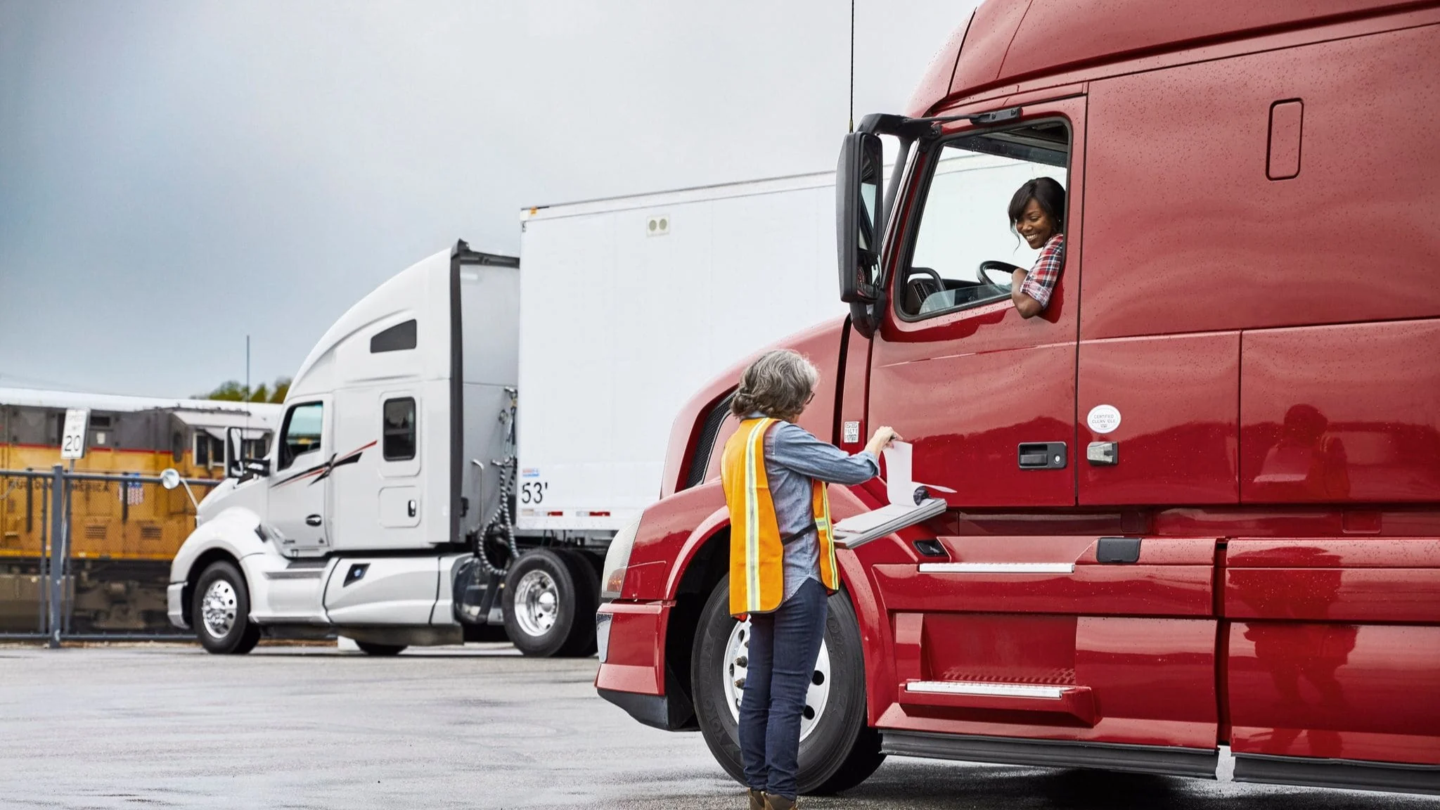 Woman talking to woman in truck.
