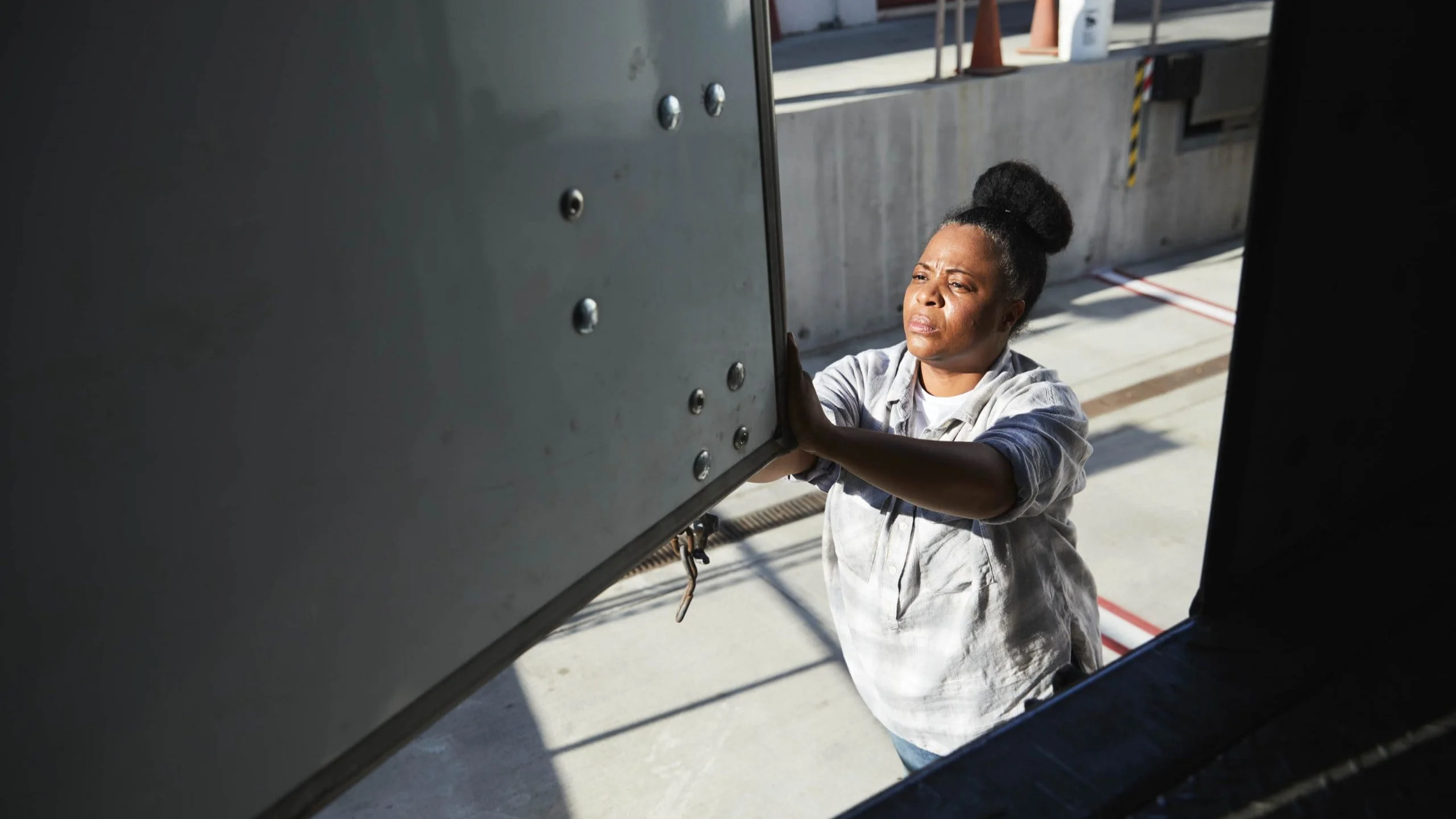 Woman working on truck.