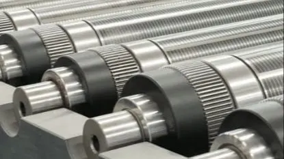 Metallic industrial rollers with threaded surfaces lined up in manufacturing equipment with red components visible.