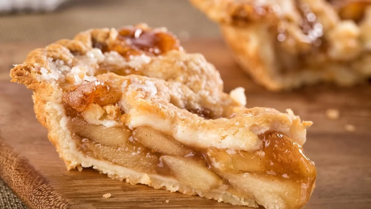 Two slices of apple pie with one blurred in the background