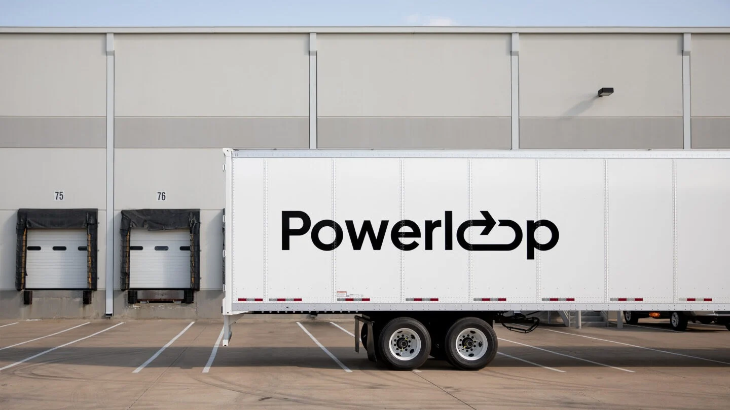 Powerloop truck trailer parked at loading docks.