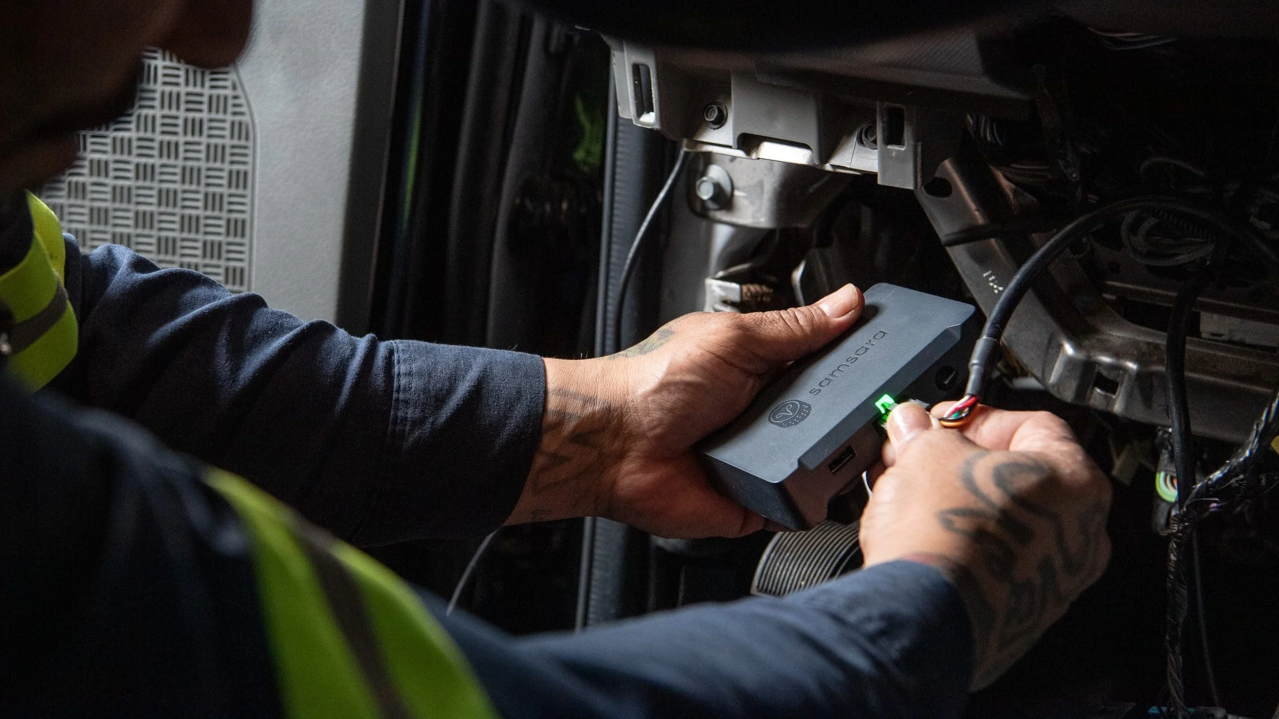 Man fixing truck battery.
