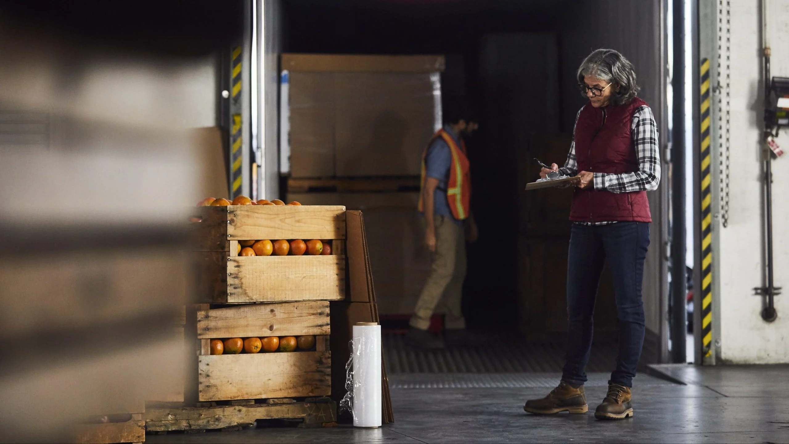 Woman writing on clipboard.