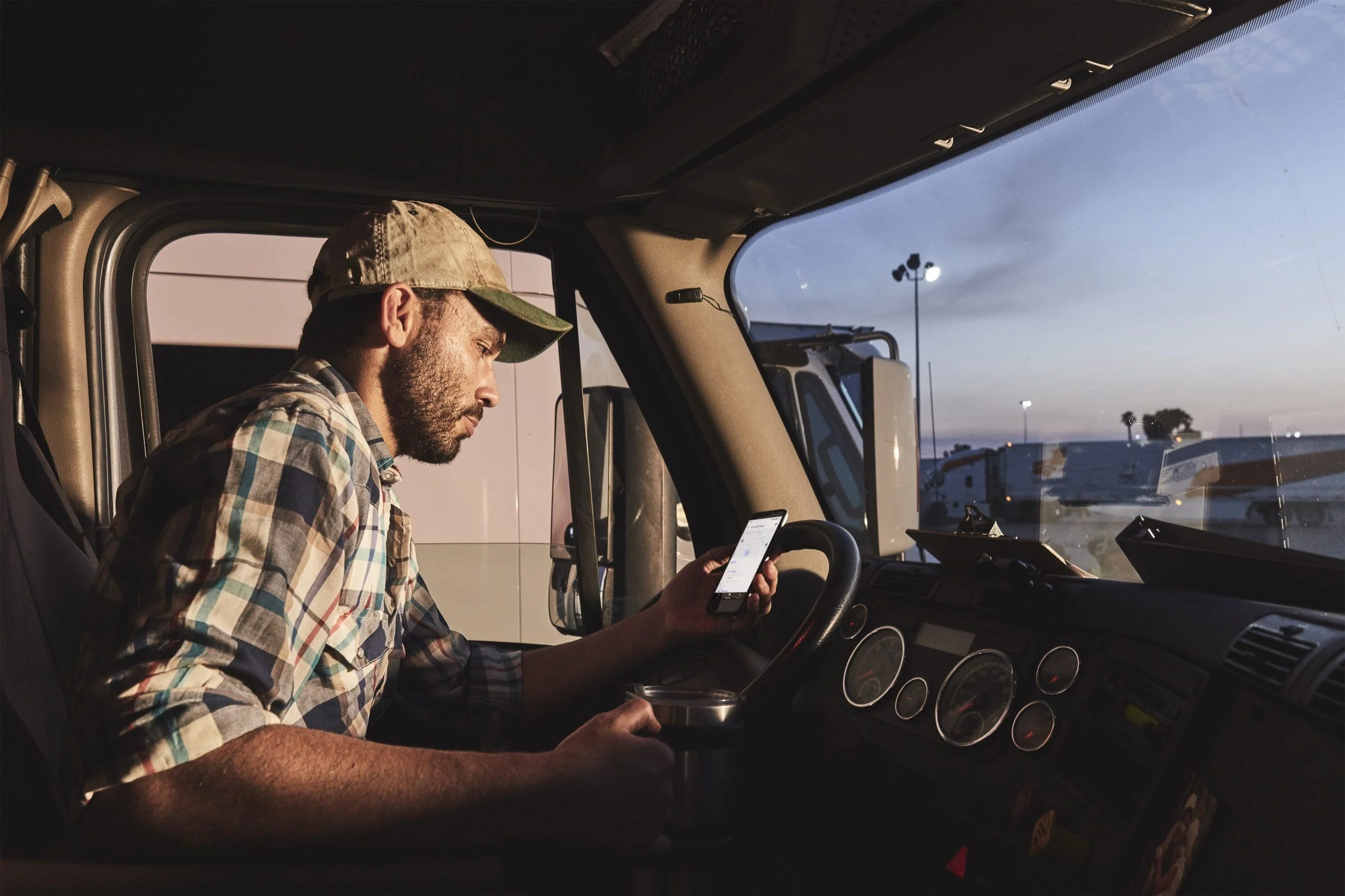 Man looking at phone in truck.