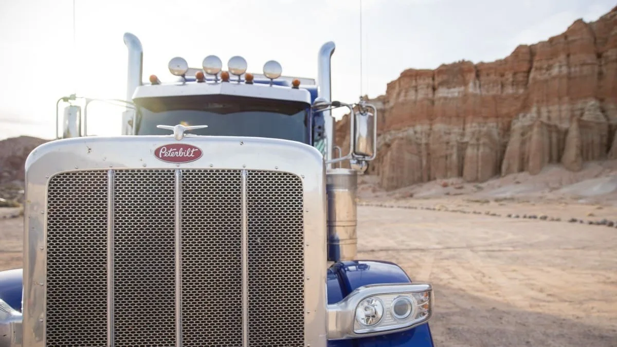 Close up of the front of a blue truck.