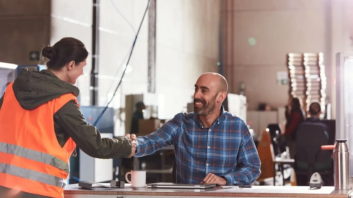 Man and woman shaking hands.