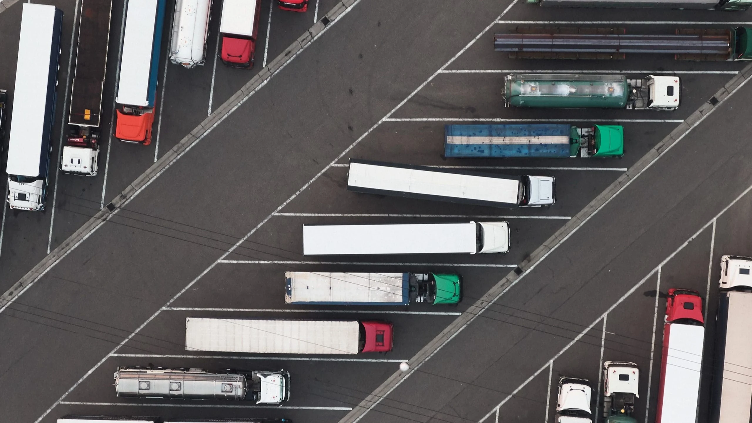 Overhead view of trucks parked in rows.