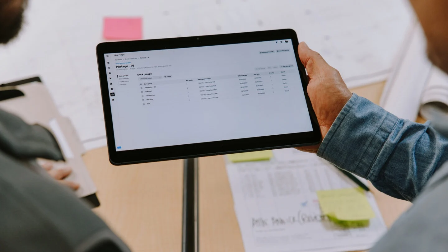 Person holding a tablet looking at shipping software.