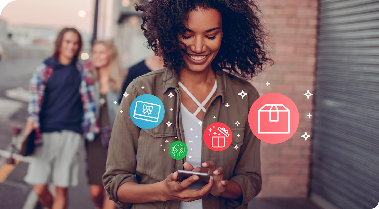 Young adult smiling while looking at phone. Logos show rewards, gift cards, and sweepstakes.