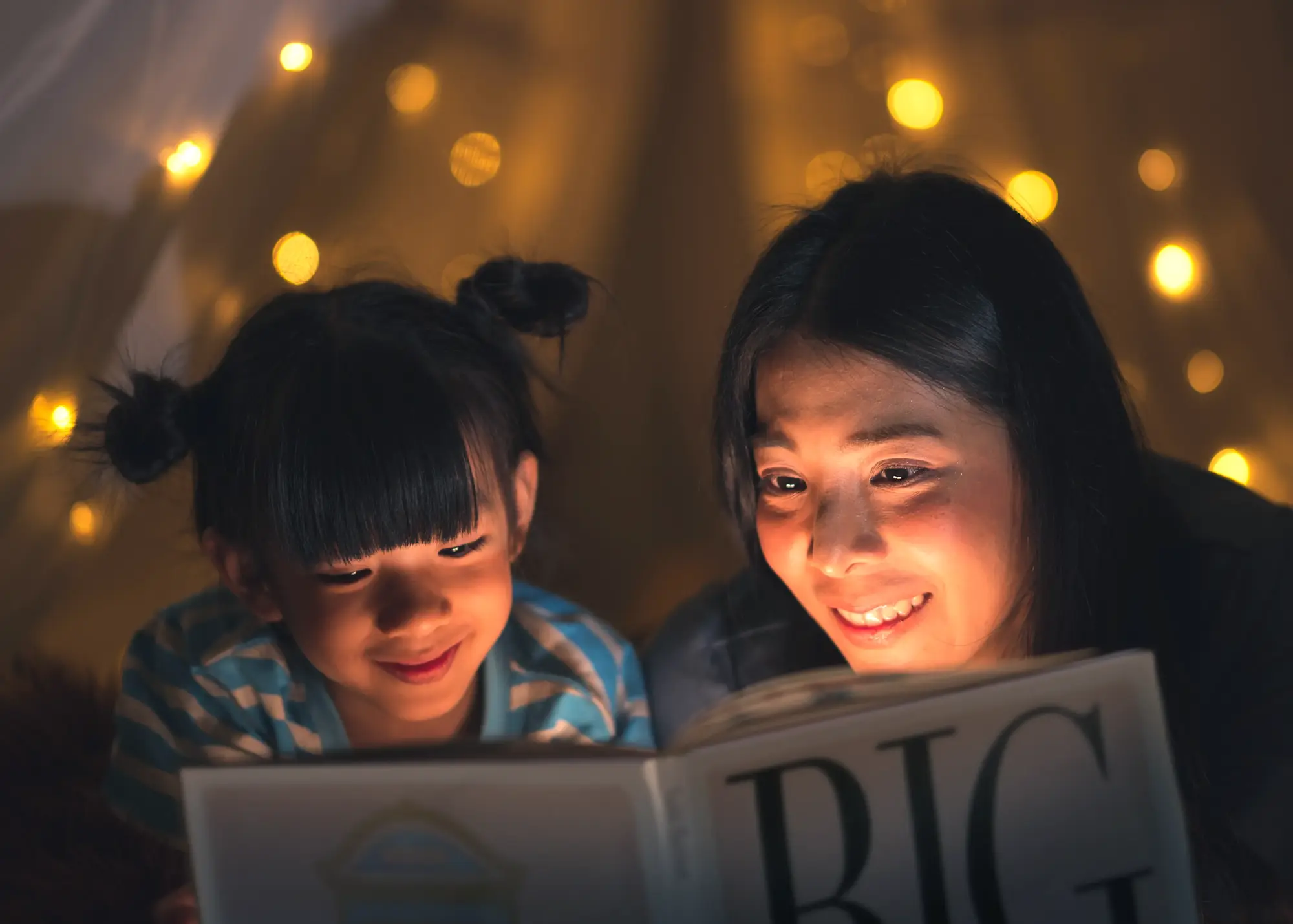Shared reading time with children enjoying book together in warm, golden-lit setting promoting literacy and togetherness