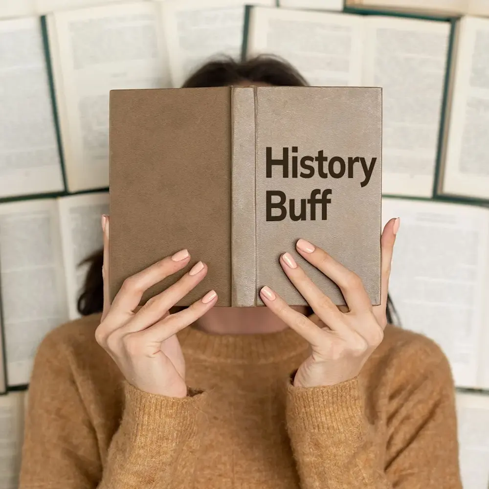 Women Holding Book in front of face entitled History Buff